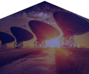 RABC-CCCR - A row of large satellite dishes silhouetted against a sunset. The path leading into the distance emphasizes the vast landscape. The sky above is filled with stars and a portion of the Milky Way, creating a serene and cosmic atmosphere.